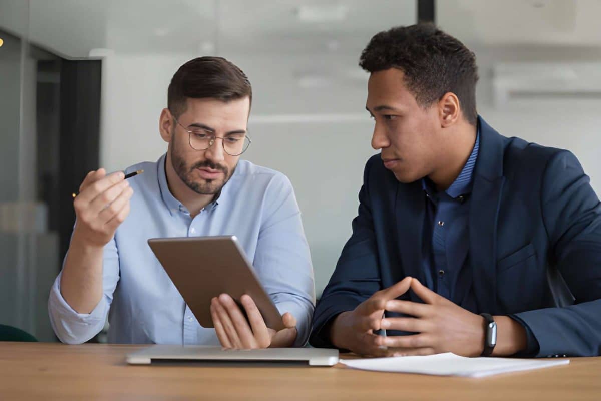 Diverse businessmen working on startup project using electronic