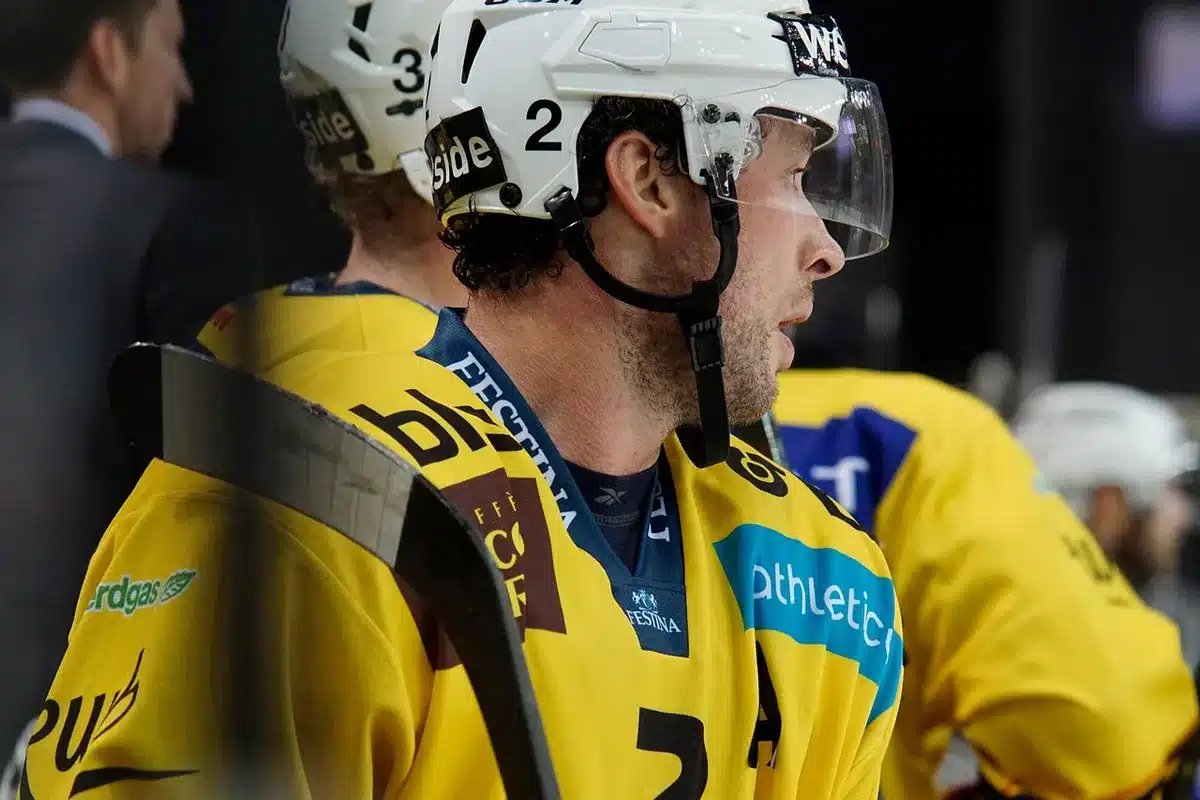Players talking in a locker room before a game, planning for the season