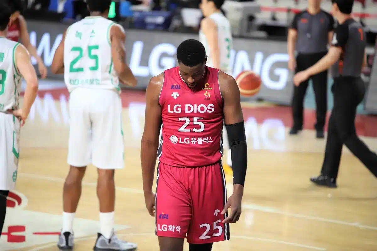 Guard shooting in a Summer League game, airborne mid-shot