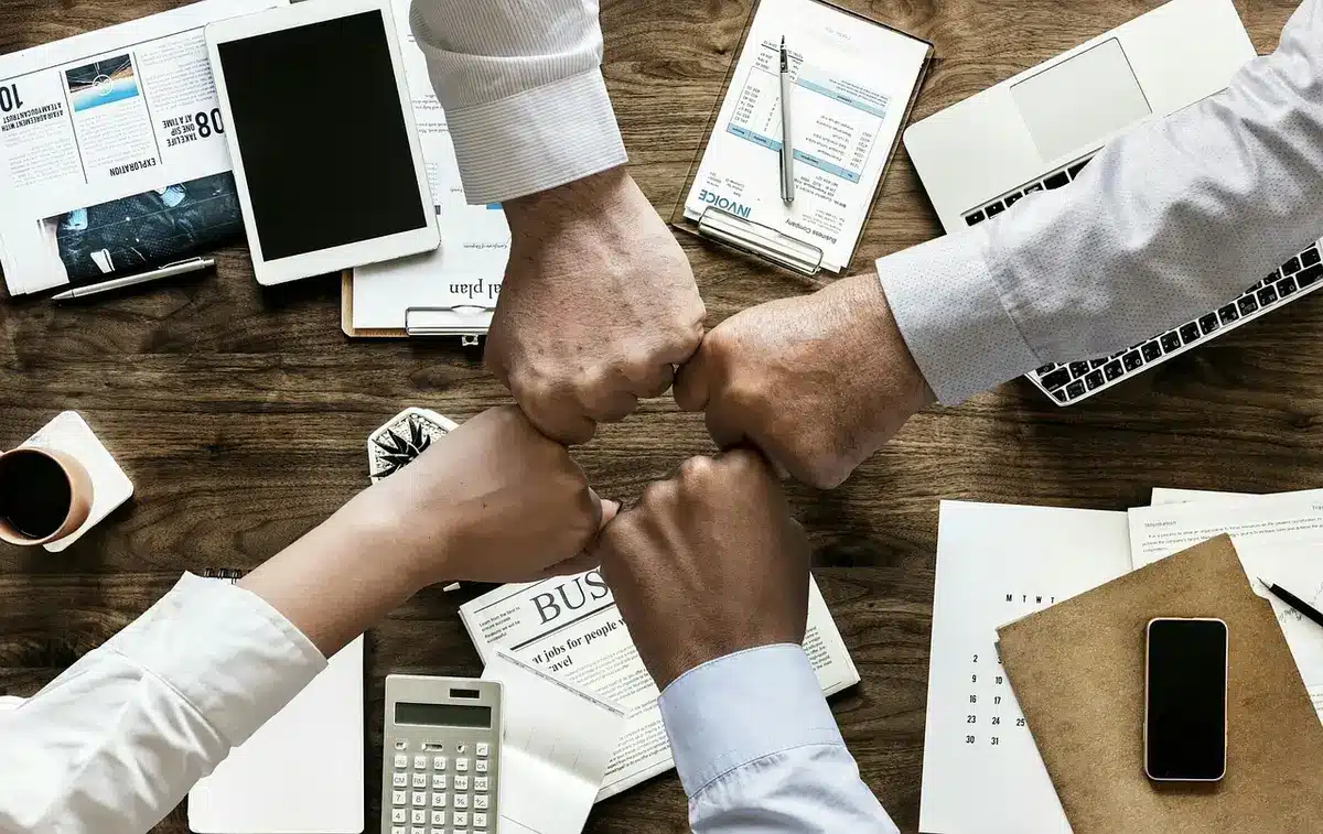 Front-office staff reviewing strategy around a table in a meeting room