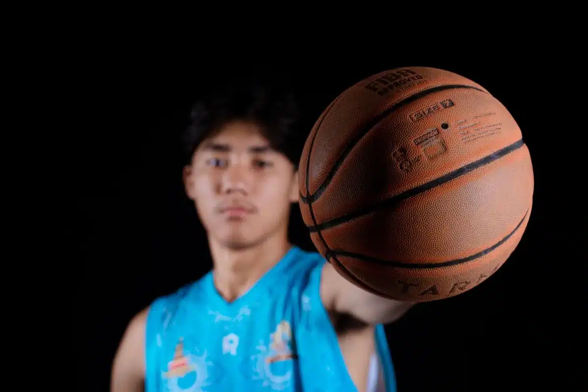 G League player entering team facility, carrying gear