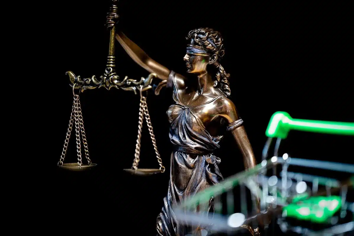 Legal documents and a gavel beside a football helmet representing Chambliss's eligibility case