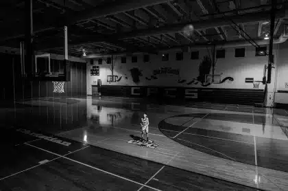 Silhouette of a center making a chest pass during a team practice on a basketball court