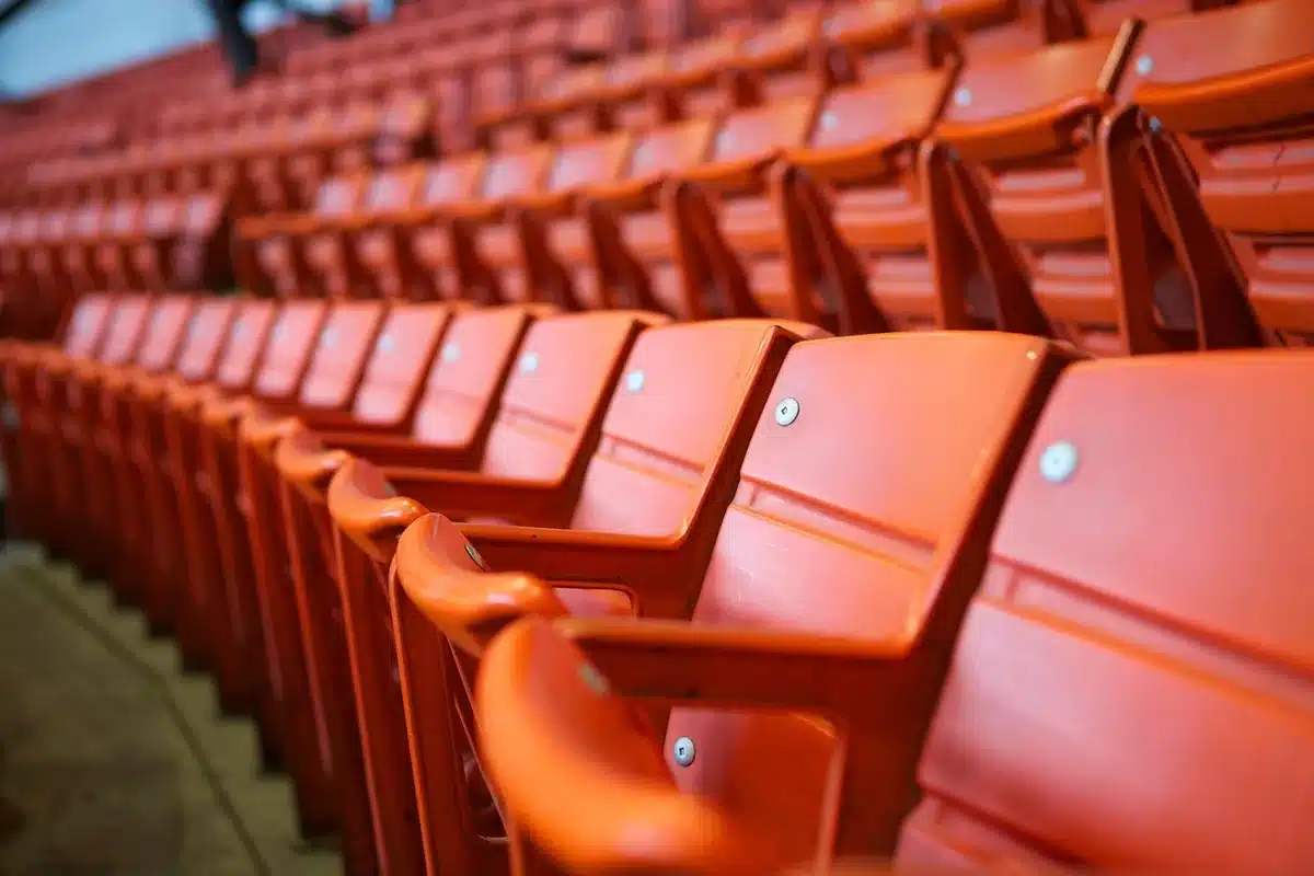 Wide view of empty football stadium seats suggesting competitive imbalance between programs
