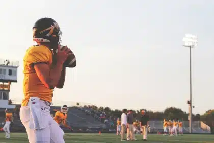 Anonymous college football players on the sideline during practice