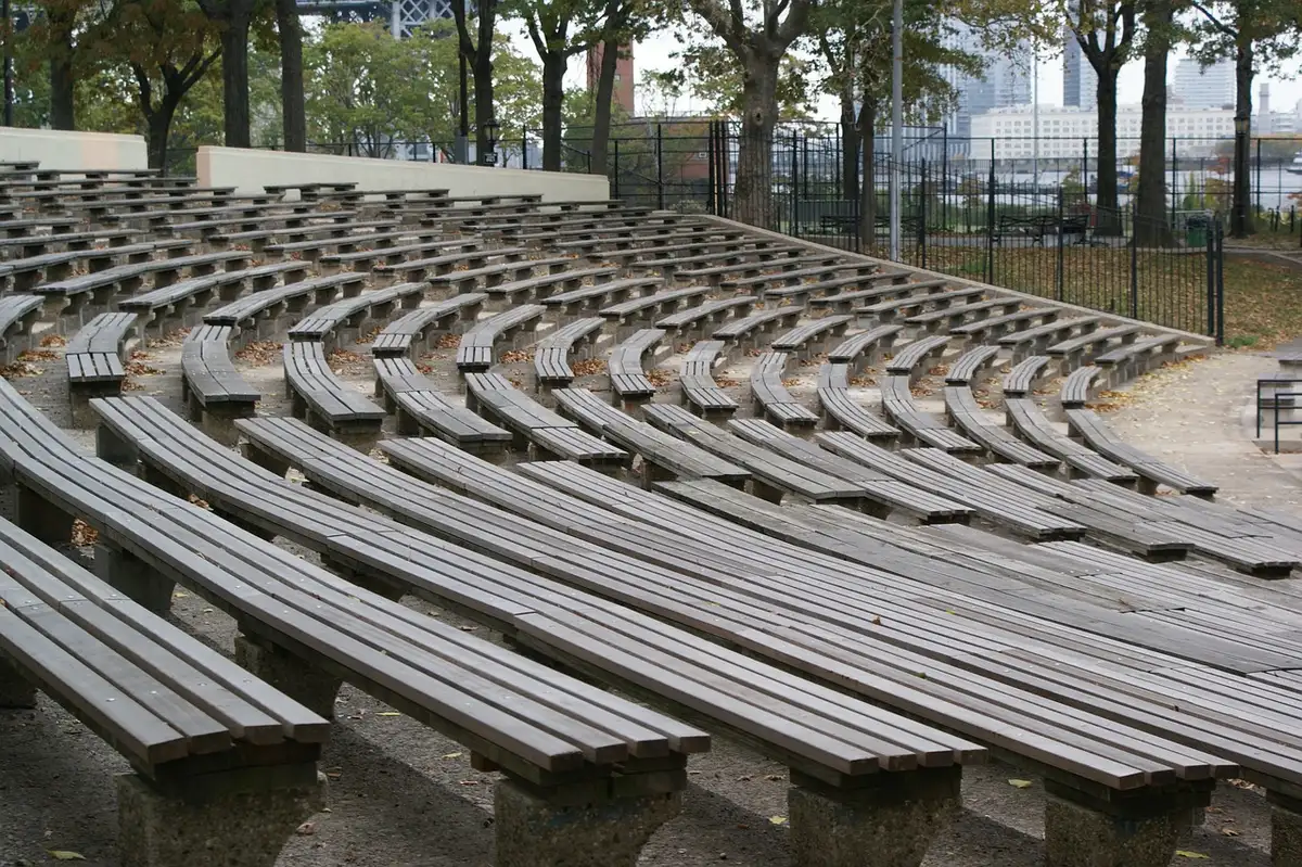 Empty arena bench with a discarded basketball jersey and sneakers representing team uncertainty